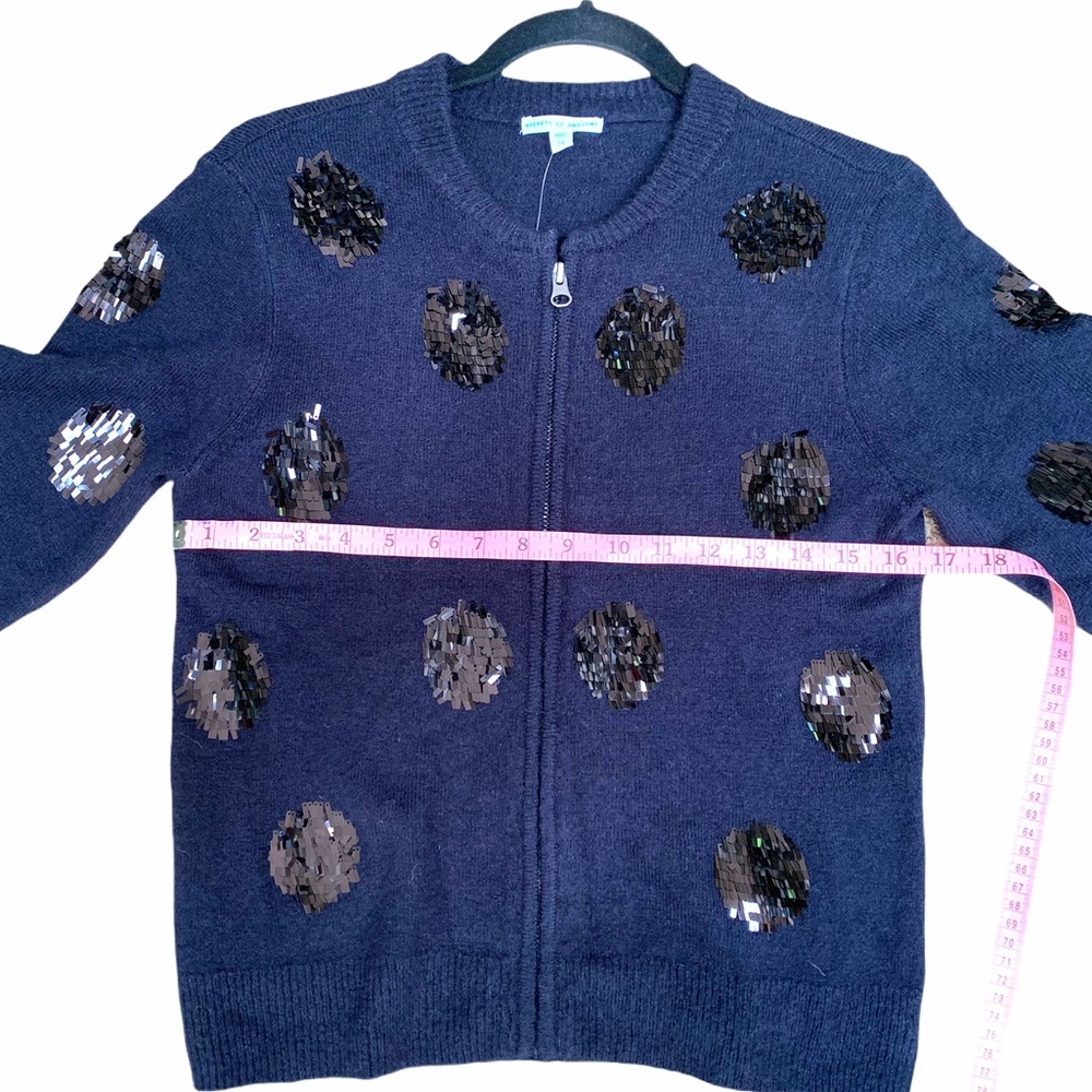 Navy blue zip-up cardigan, sequined polka dots.